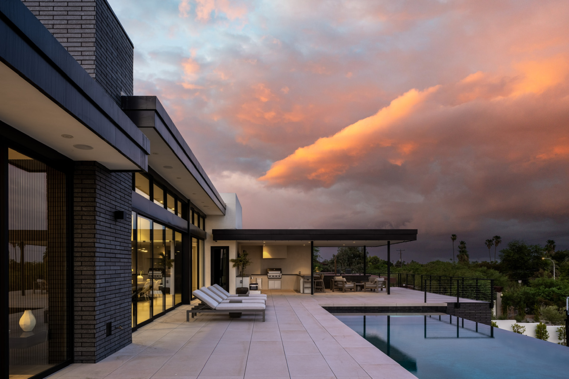 Sunset pool terrace facing the outdoor kitchen