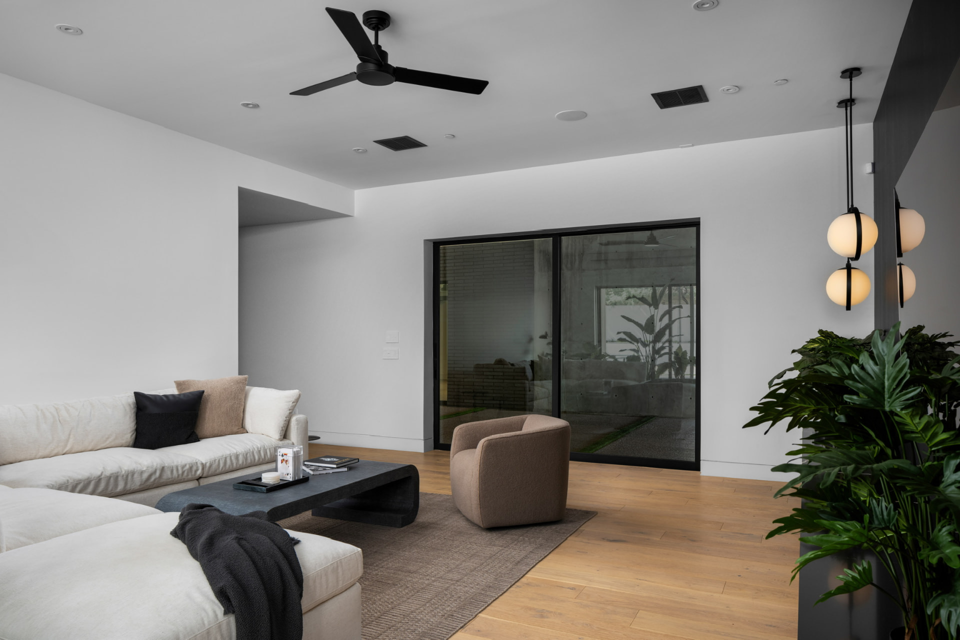 Living room with globe pendants and courtyard doors