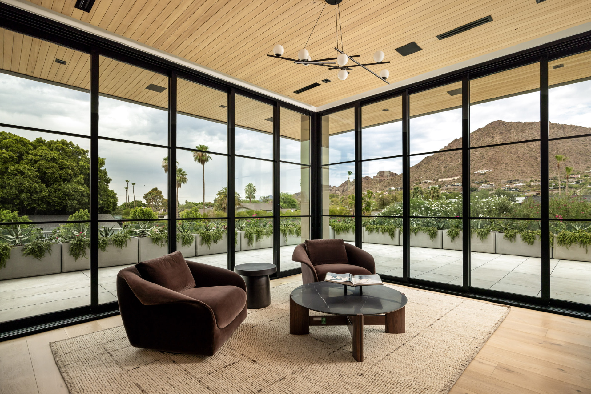 Glass-wrapped lounge with mountain views