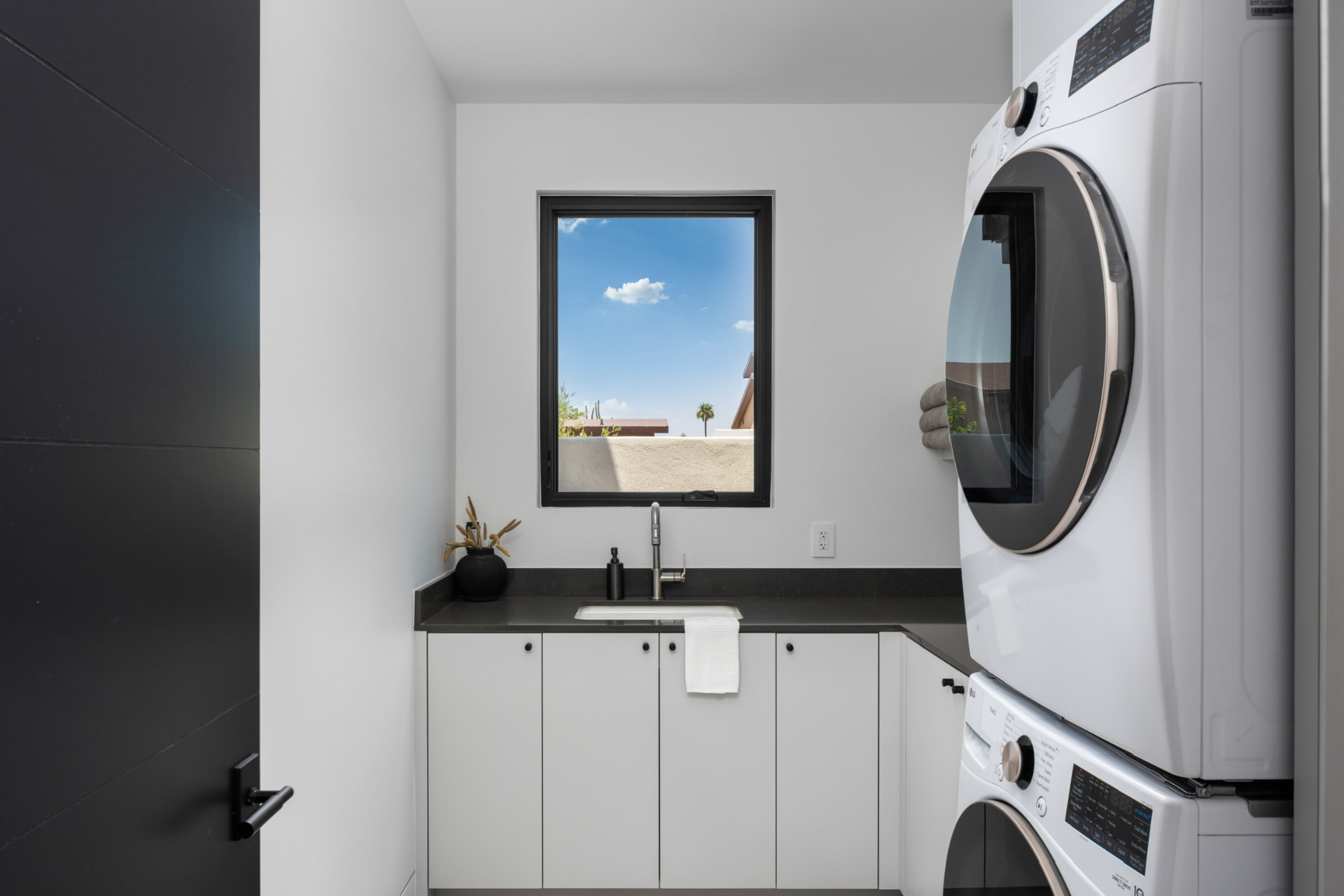 Laundry room with stacked washer and dryer