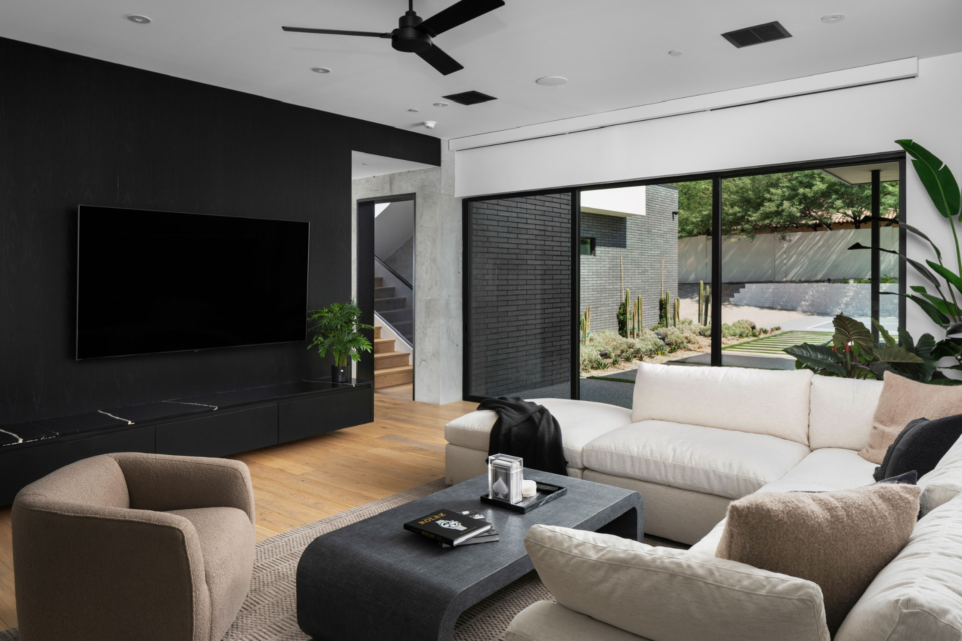 Living room with black media wall and white sectional