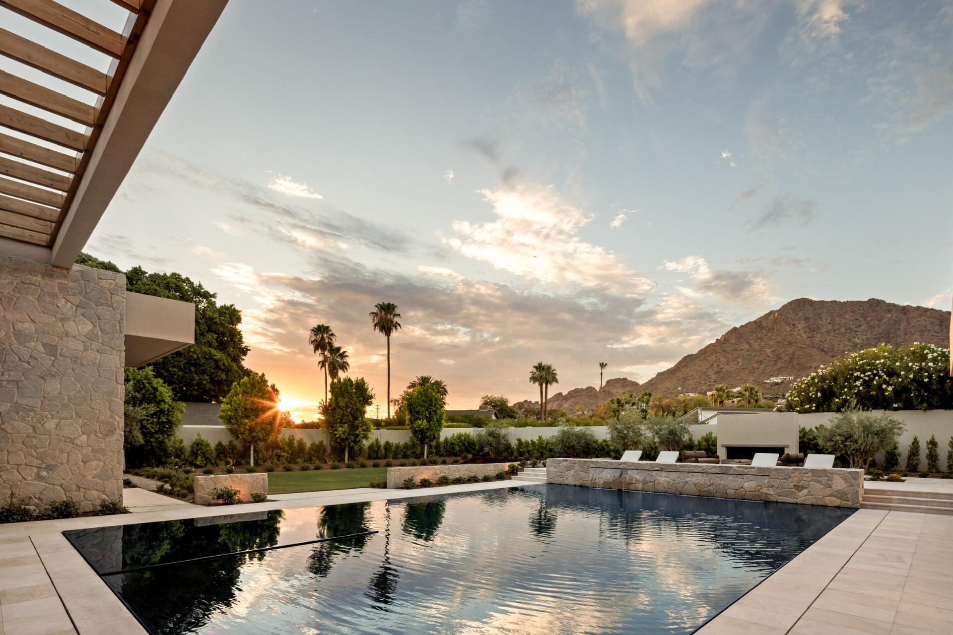 Pool terrace at sunset with mountain views