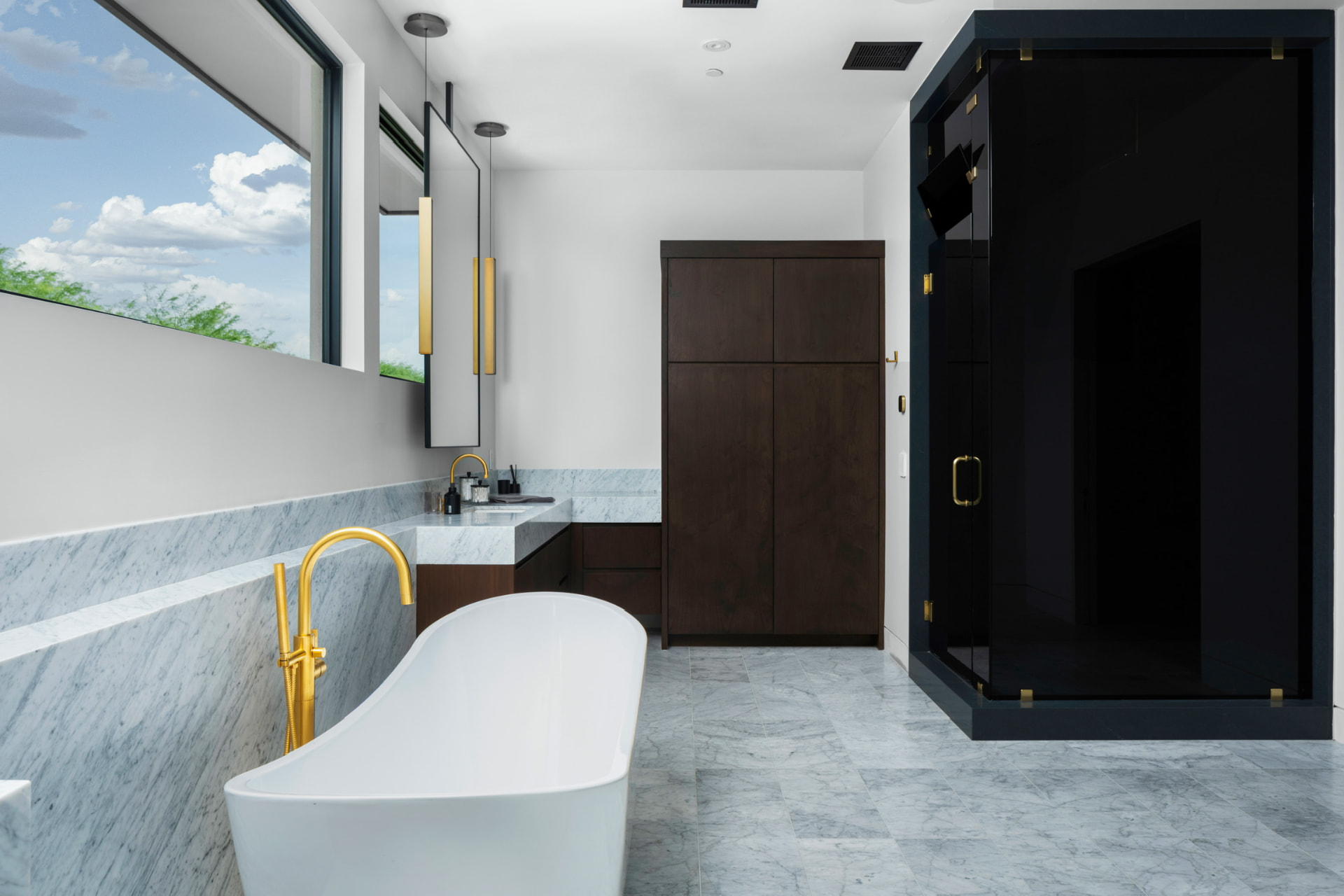 Primary bathroom with soaking tub and dark glass shower