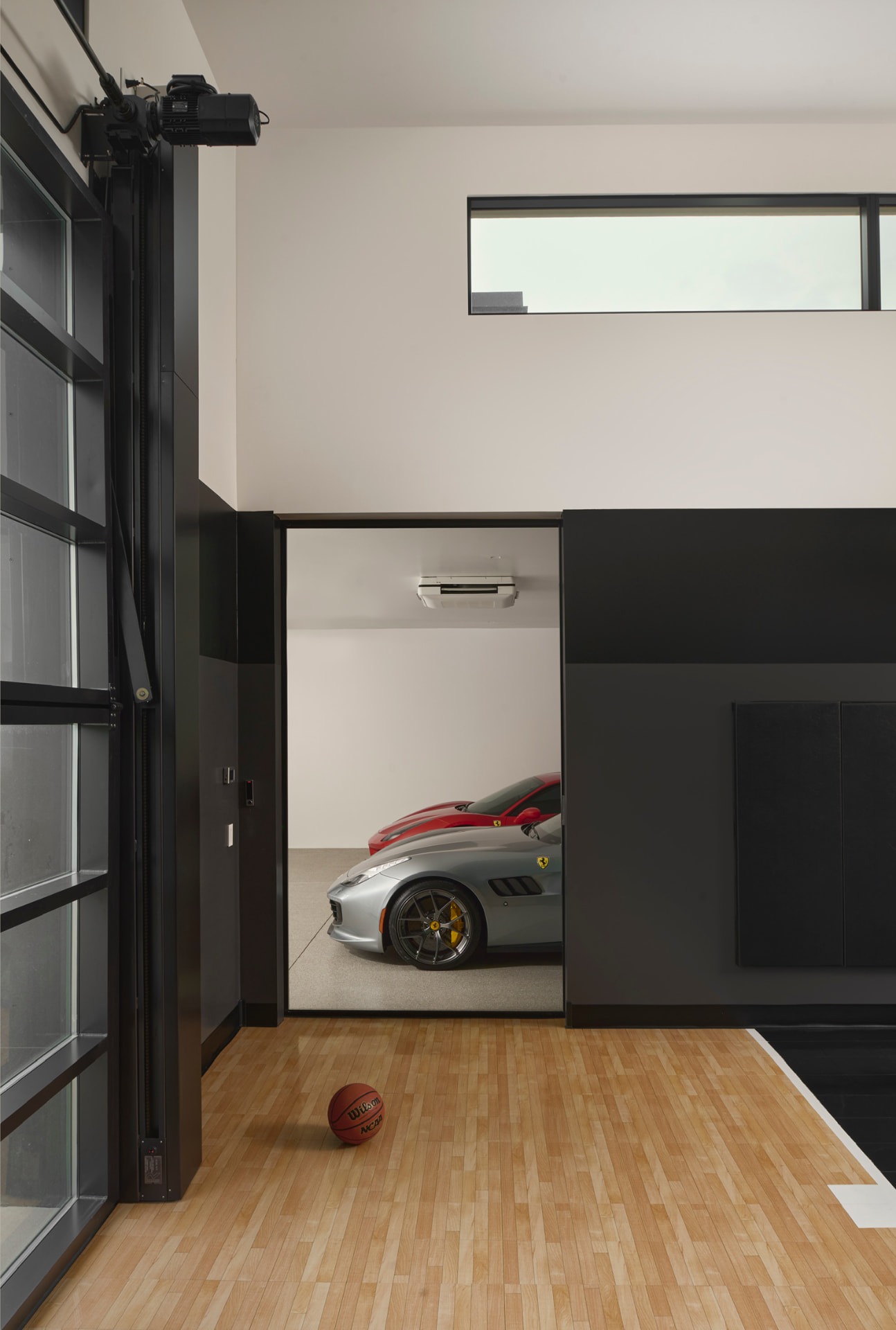 Indoor sport court opening to the collector's garage