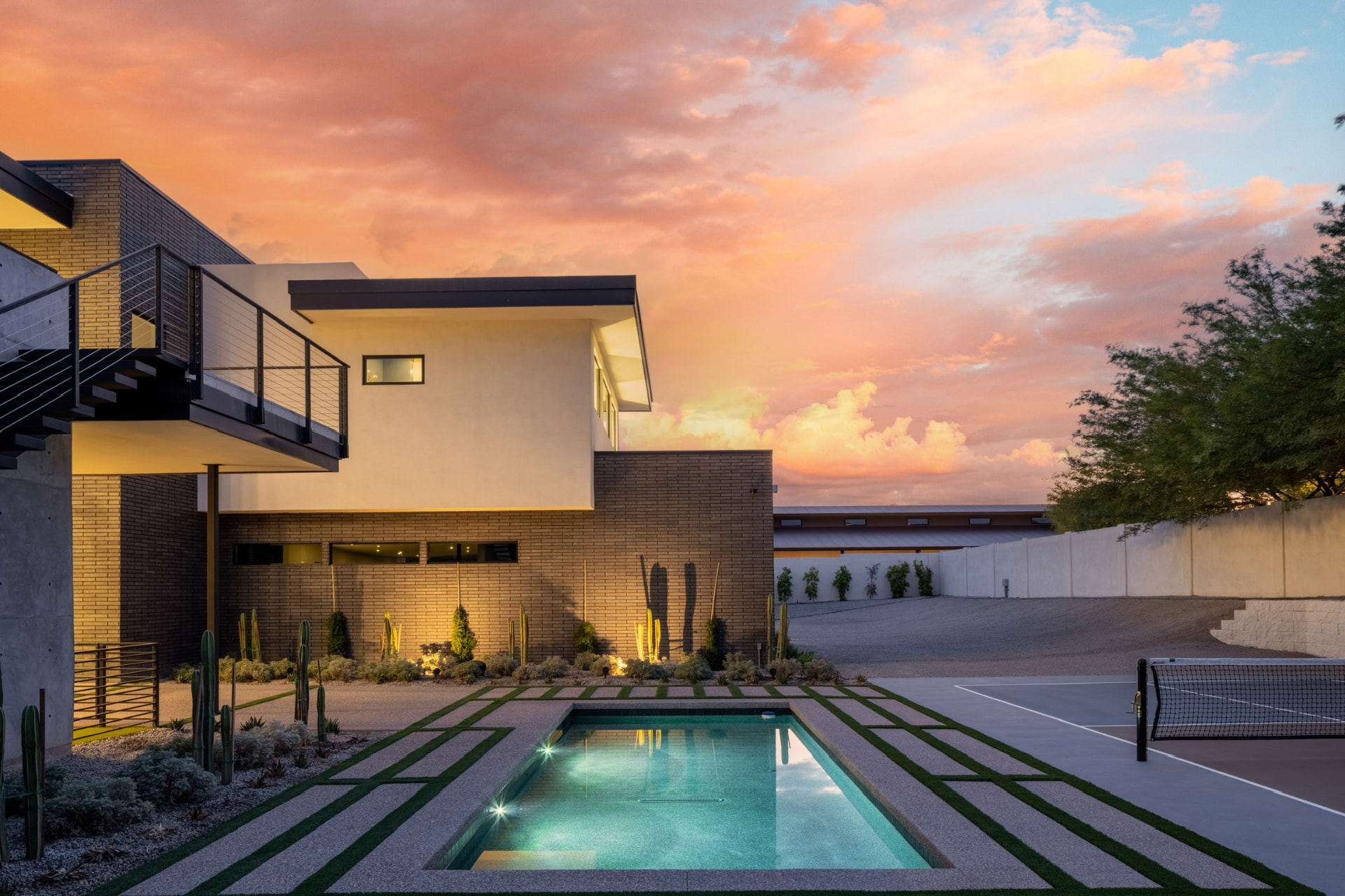 Courtyard plunge pool and sports court at sunset