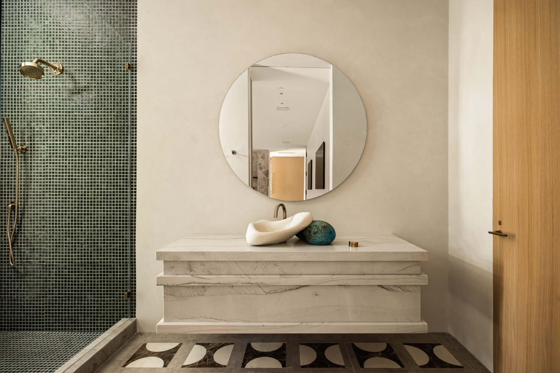 Marble vanity and mosaic-tiled shower