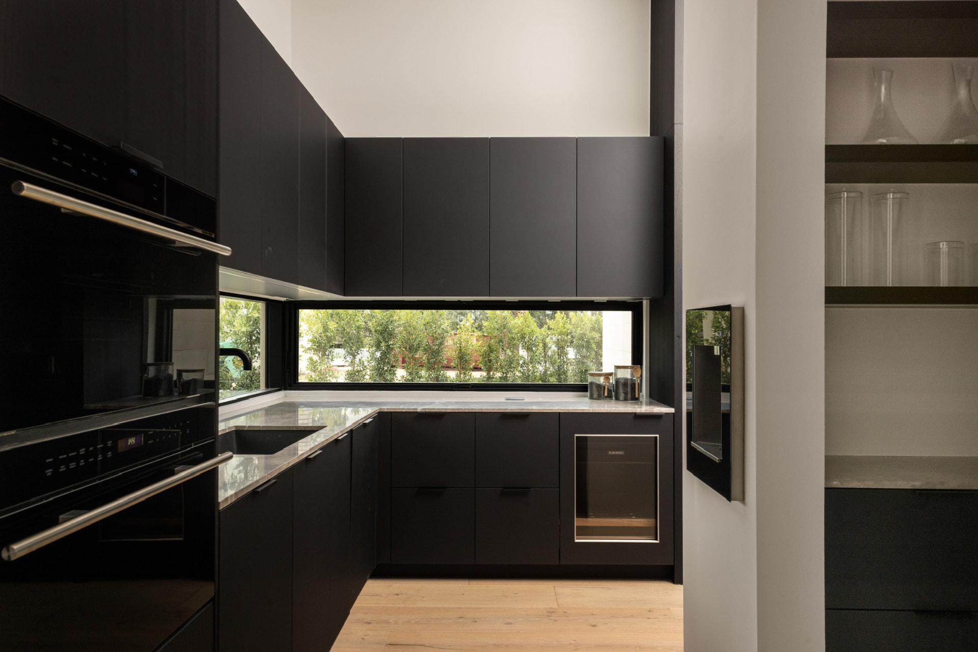 Scullery with garden window and black cabinetry