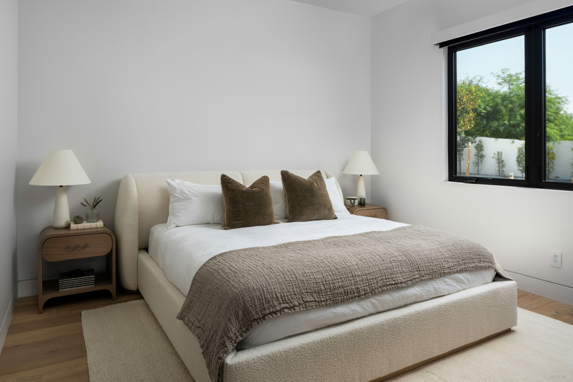 Guest bedroom with cream upholstered bed