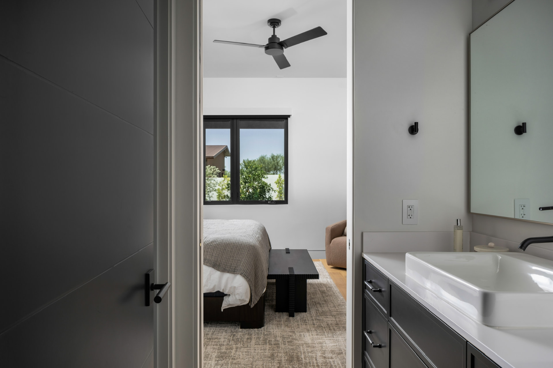 Guest vanity with a view into the adjoining bedroom