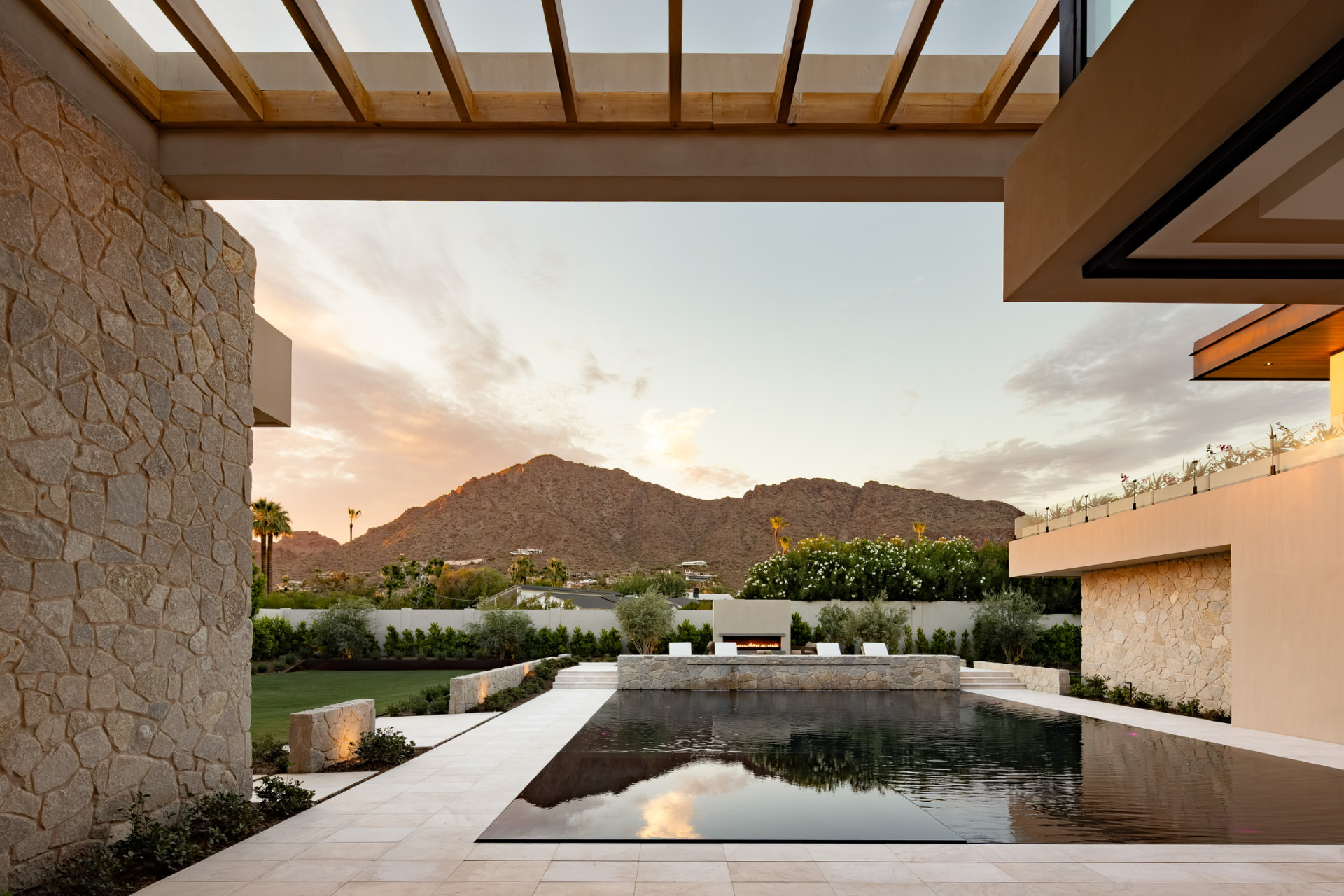 Timber pergola over the pool terrace at dusk