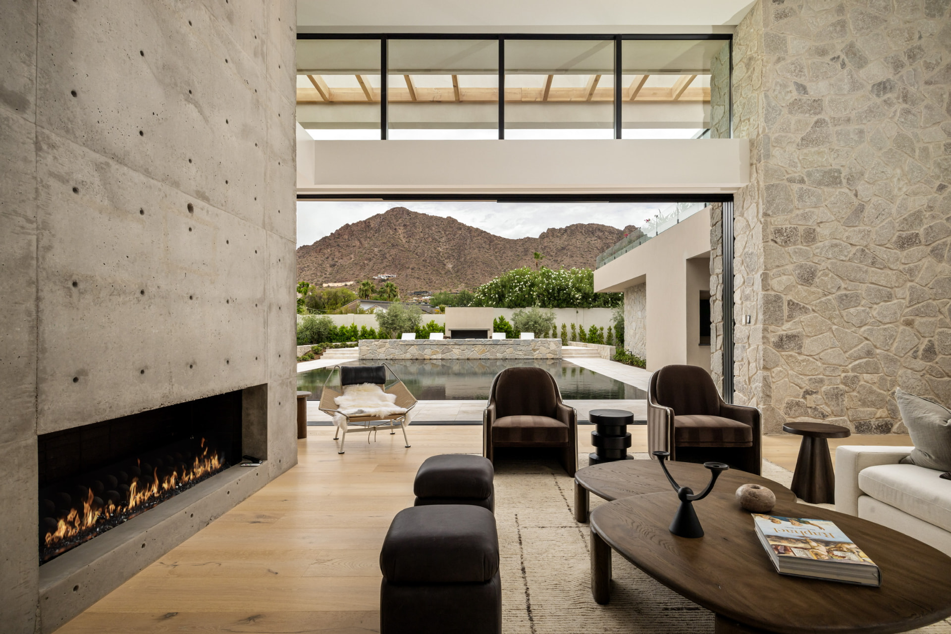 Living room with concrete fireplace and mountain views