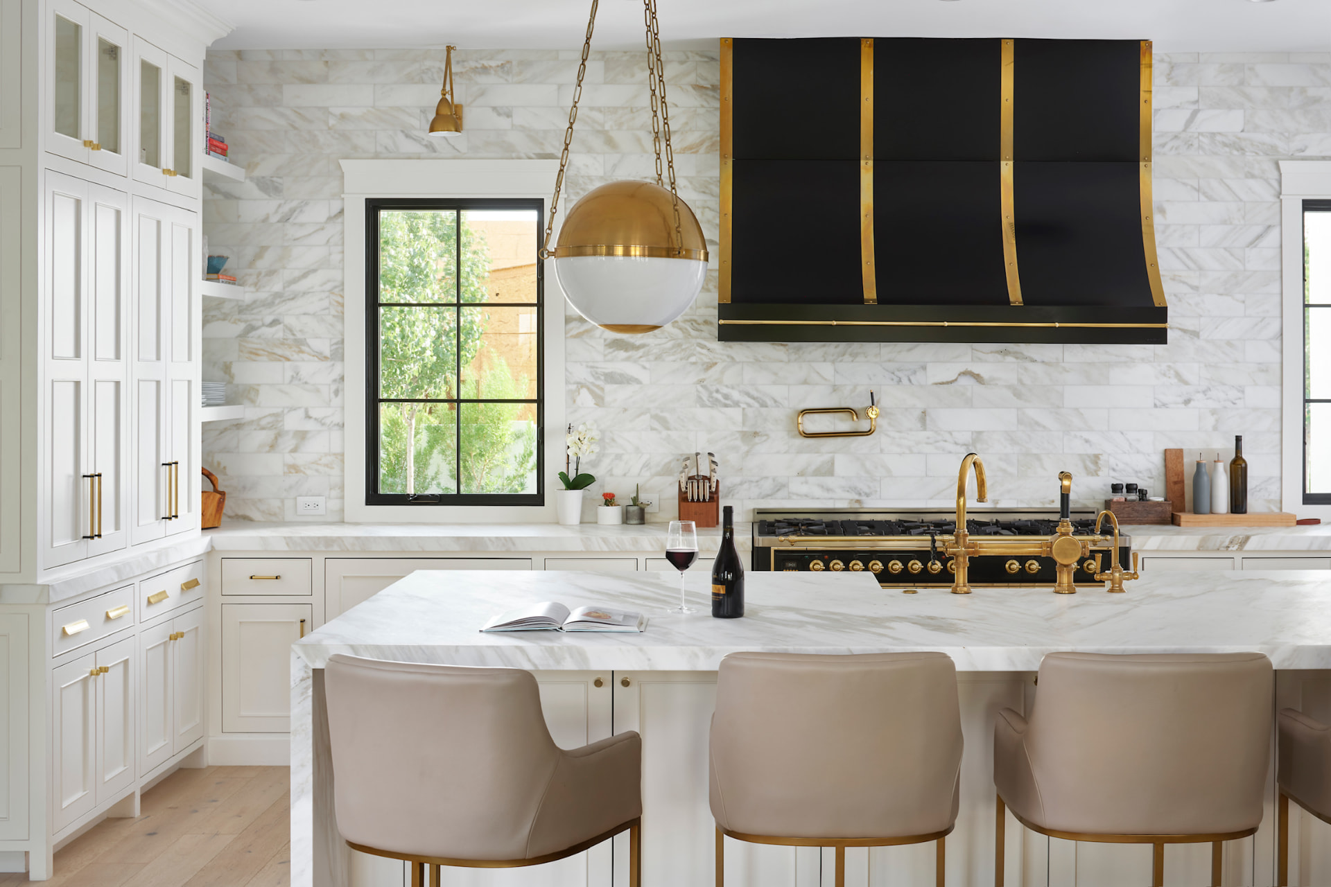 Kitchen with marble island and brass accents