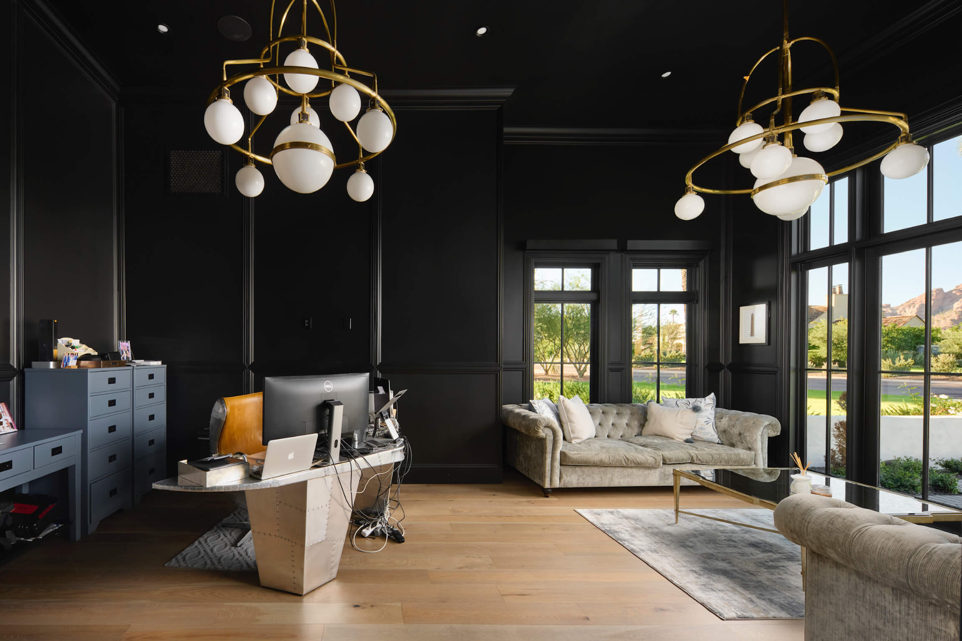 Twin brass chandeliers over the study and lounge