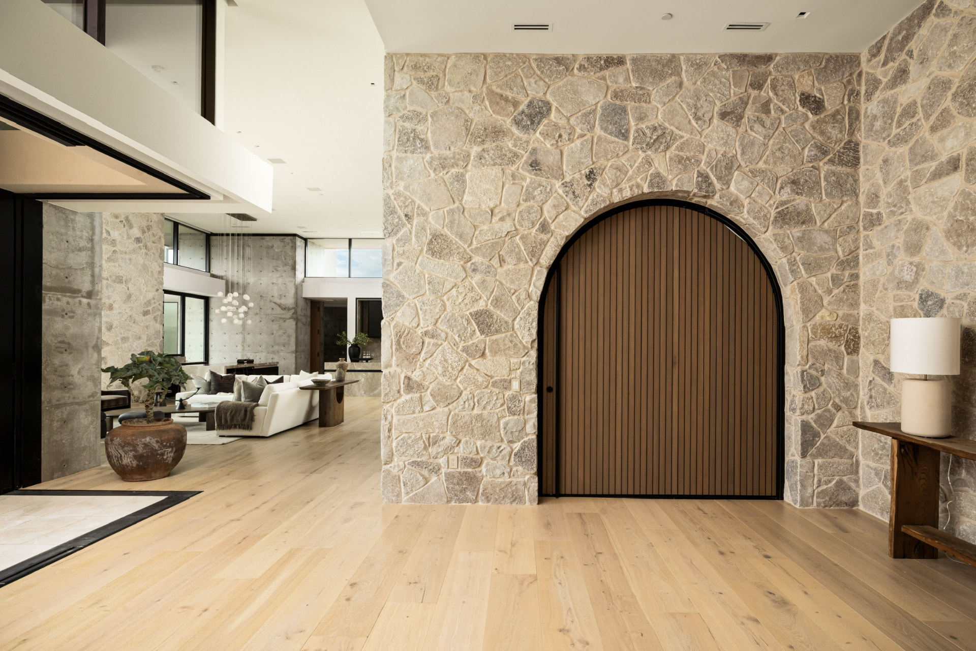 Arched entry with stone walls and white oak floors