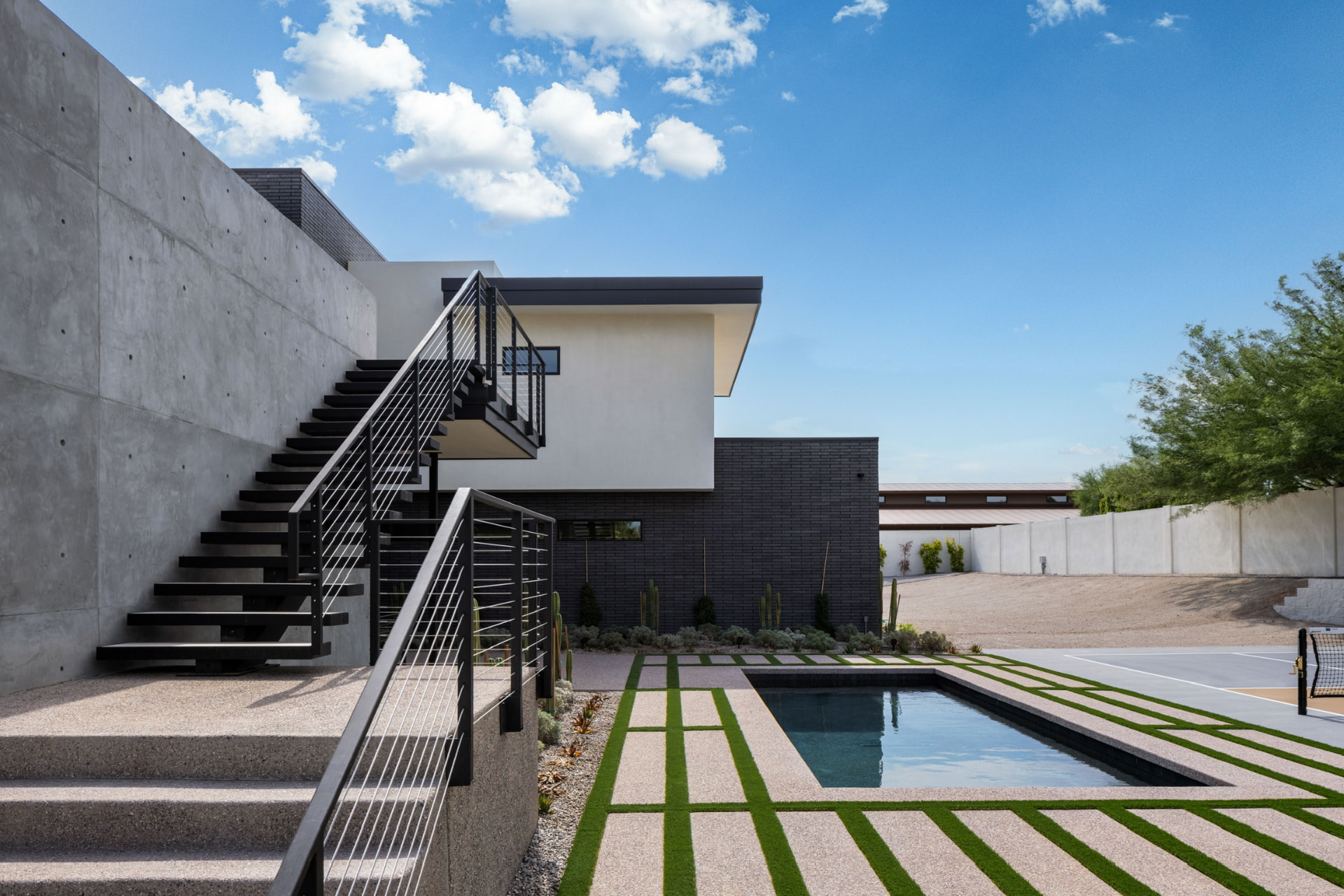 Exterior staircase beside the courtyard pool