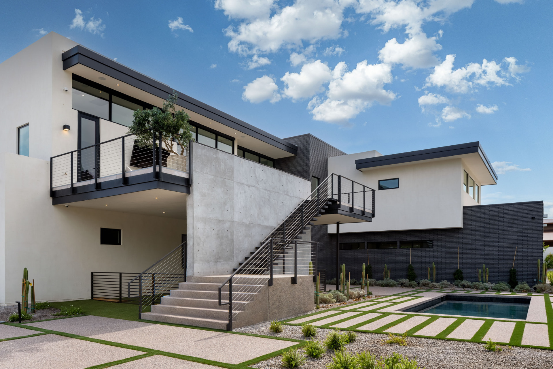 Rear exterior with stairs and courtyard pool