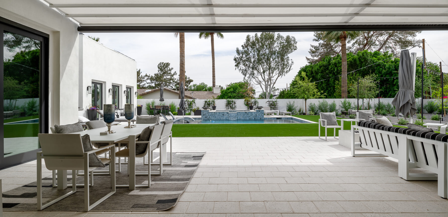 Covered outdoor dining overlooking the pool