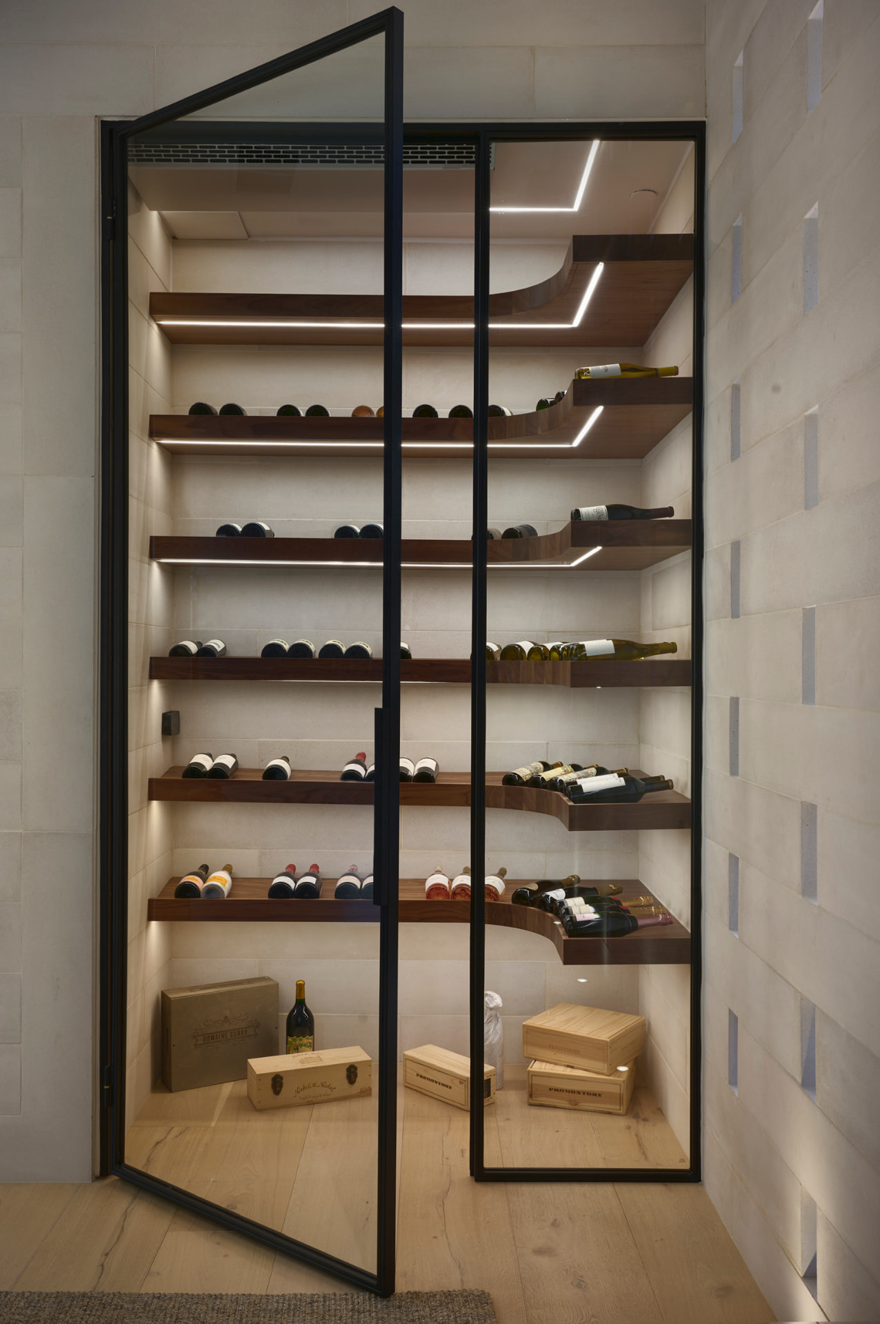 Glass wine cellar with floating walnut shelves