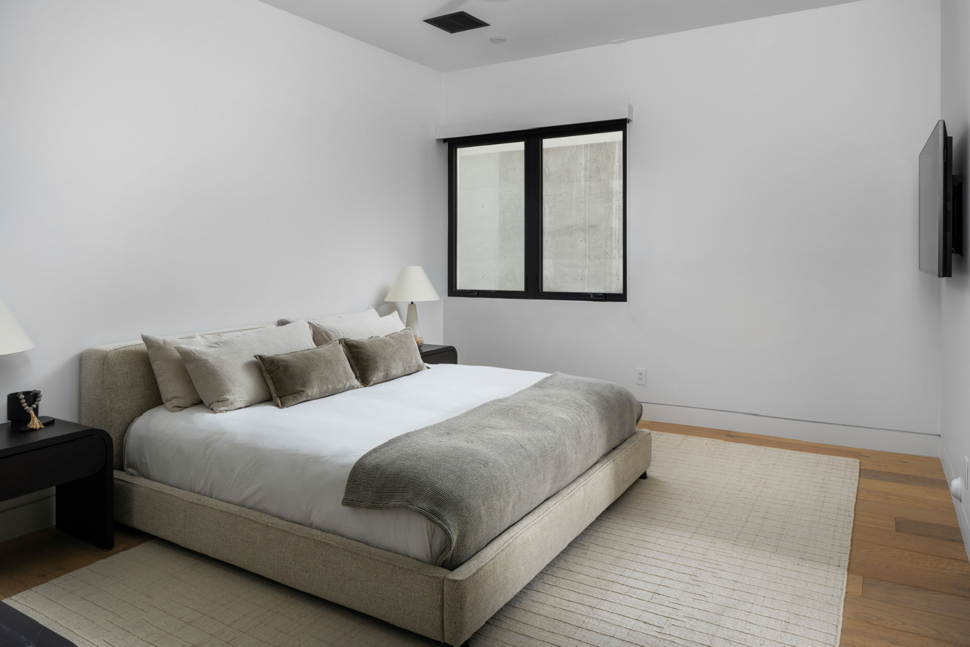 Guest bedroom with gray upholstered bed