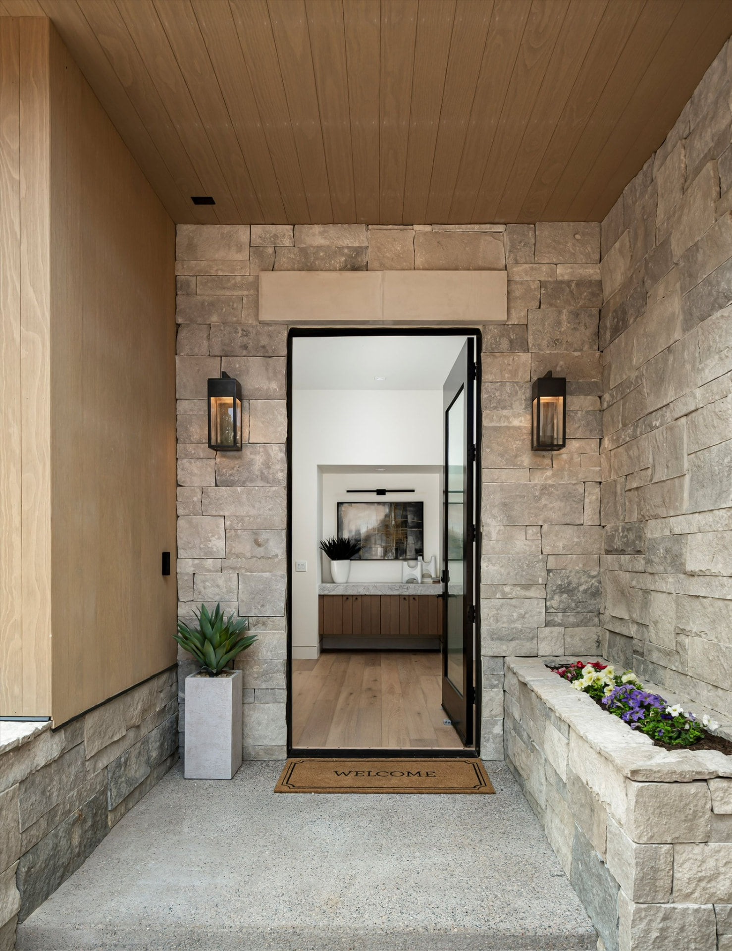 Stone entry with wood-plank ceiling