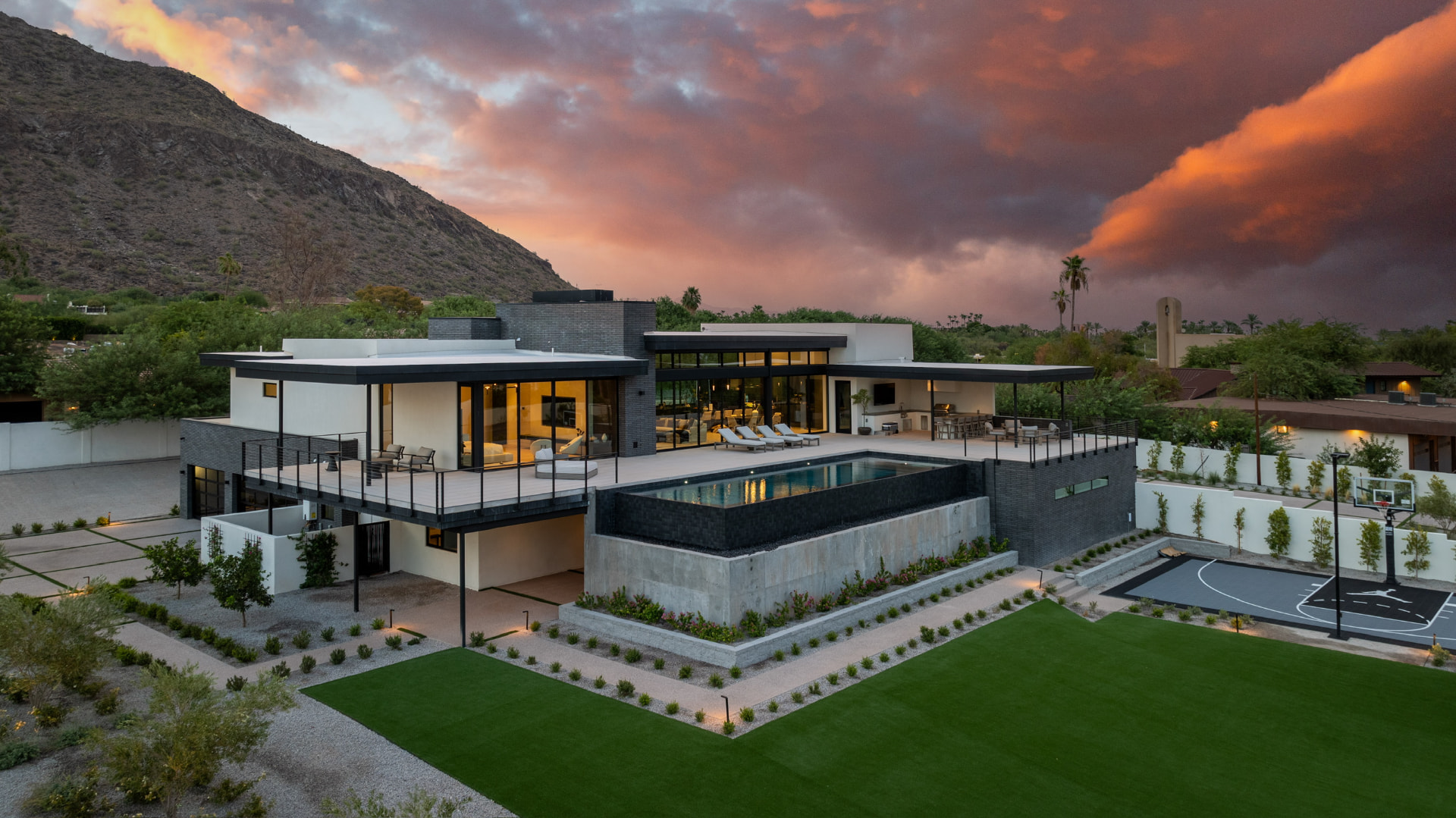 Aerial sunset view of the residence and landscaped grounds