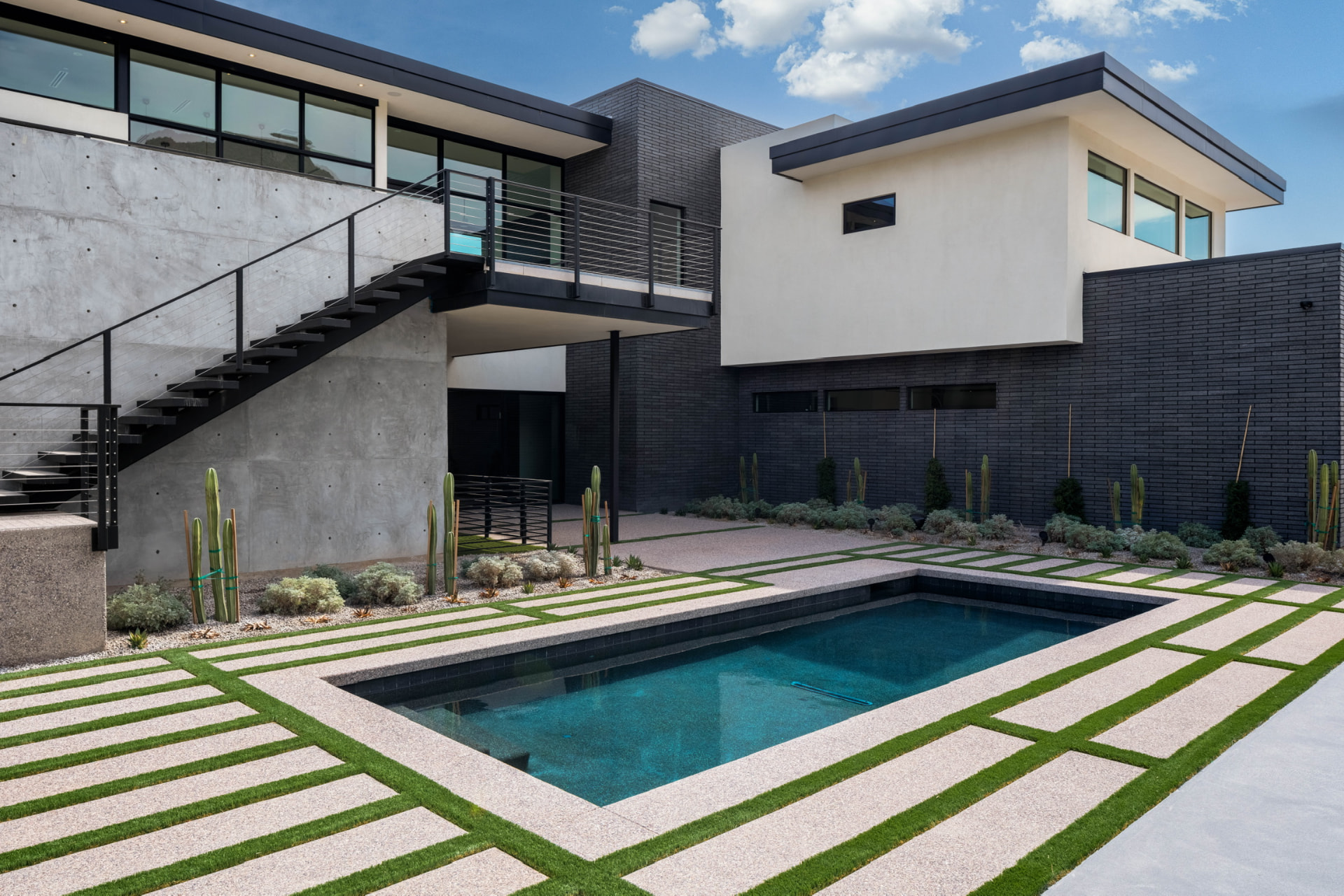 Courtyard pool with concrete stairs and desert plantings