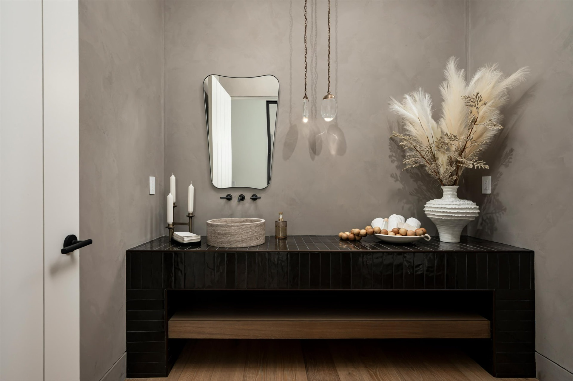 Powder bath with black tile vanity