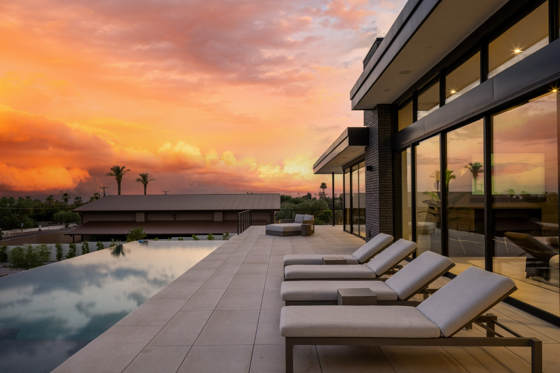 Poolside loungers beneath a glowing sunset