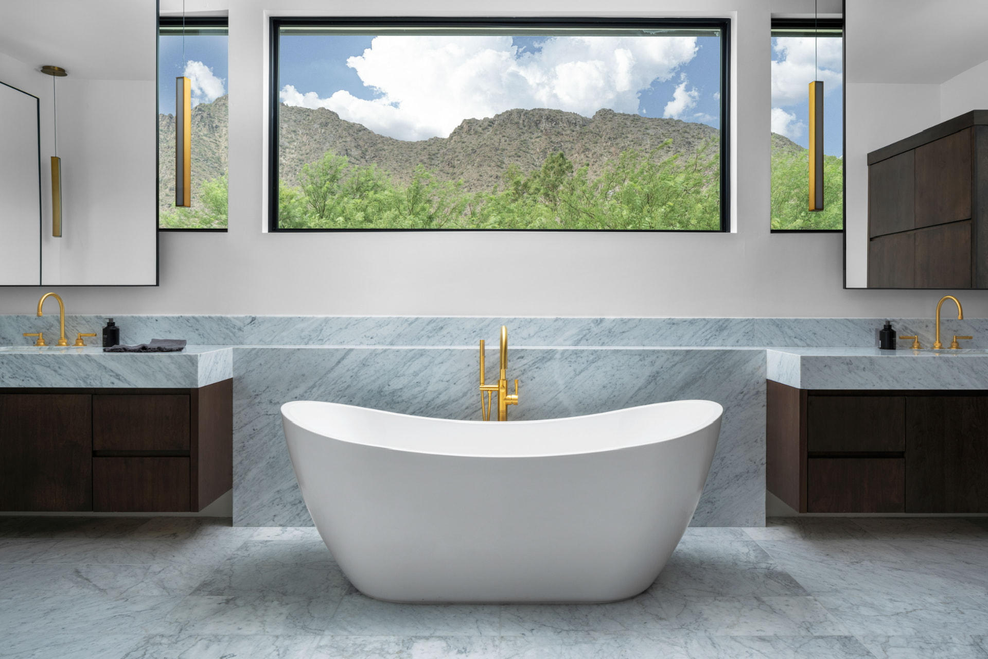 Freestanding bathtub beneath the mountain-view window