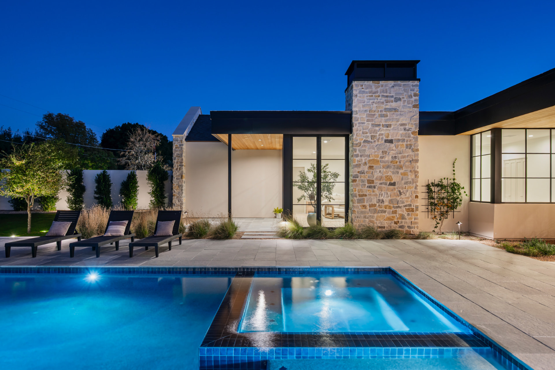 Illuminated pool and home at night