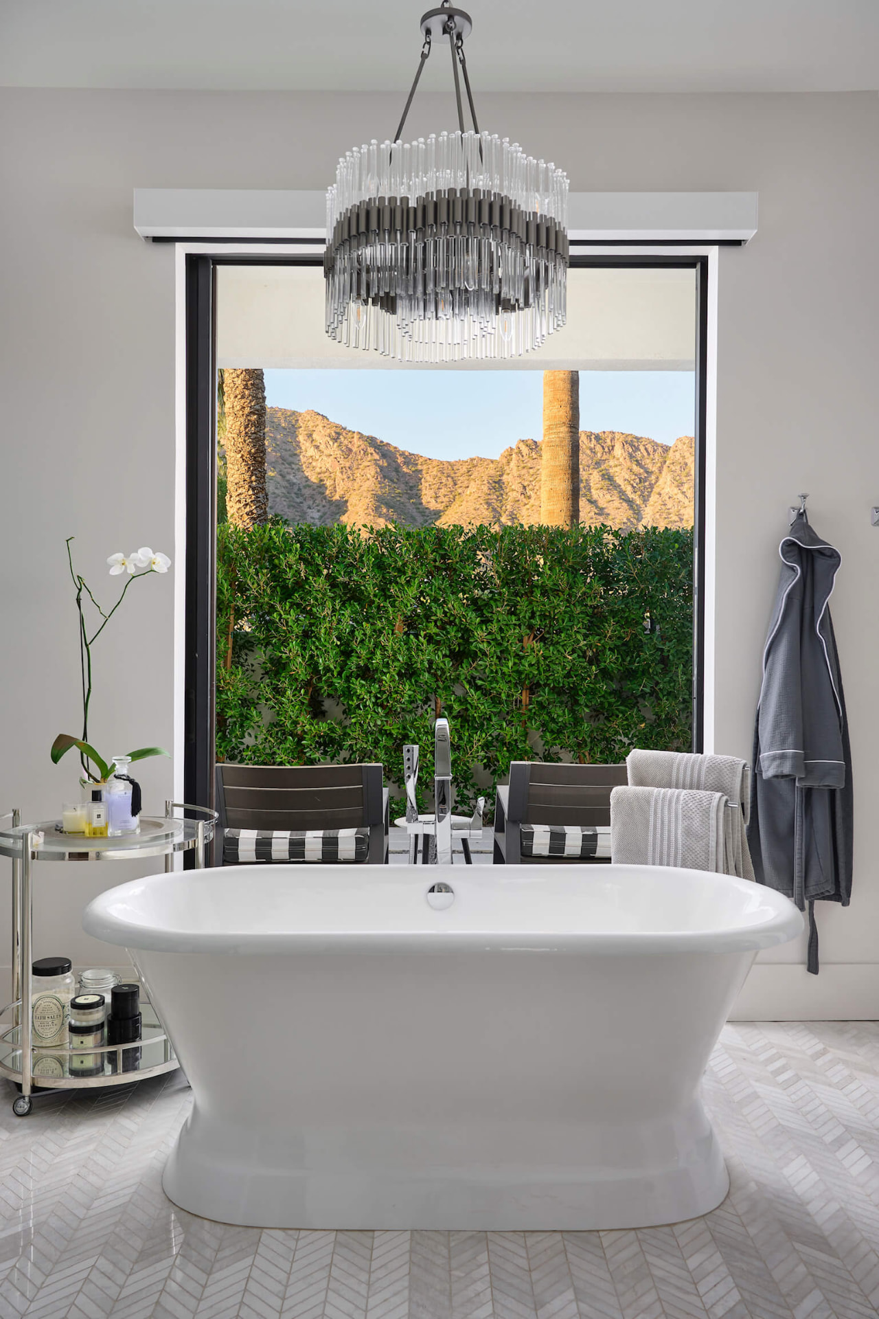 Freestanding tub beneath the chandelier
