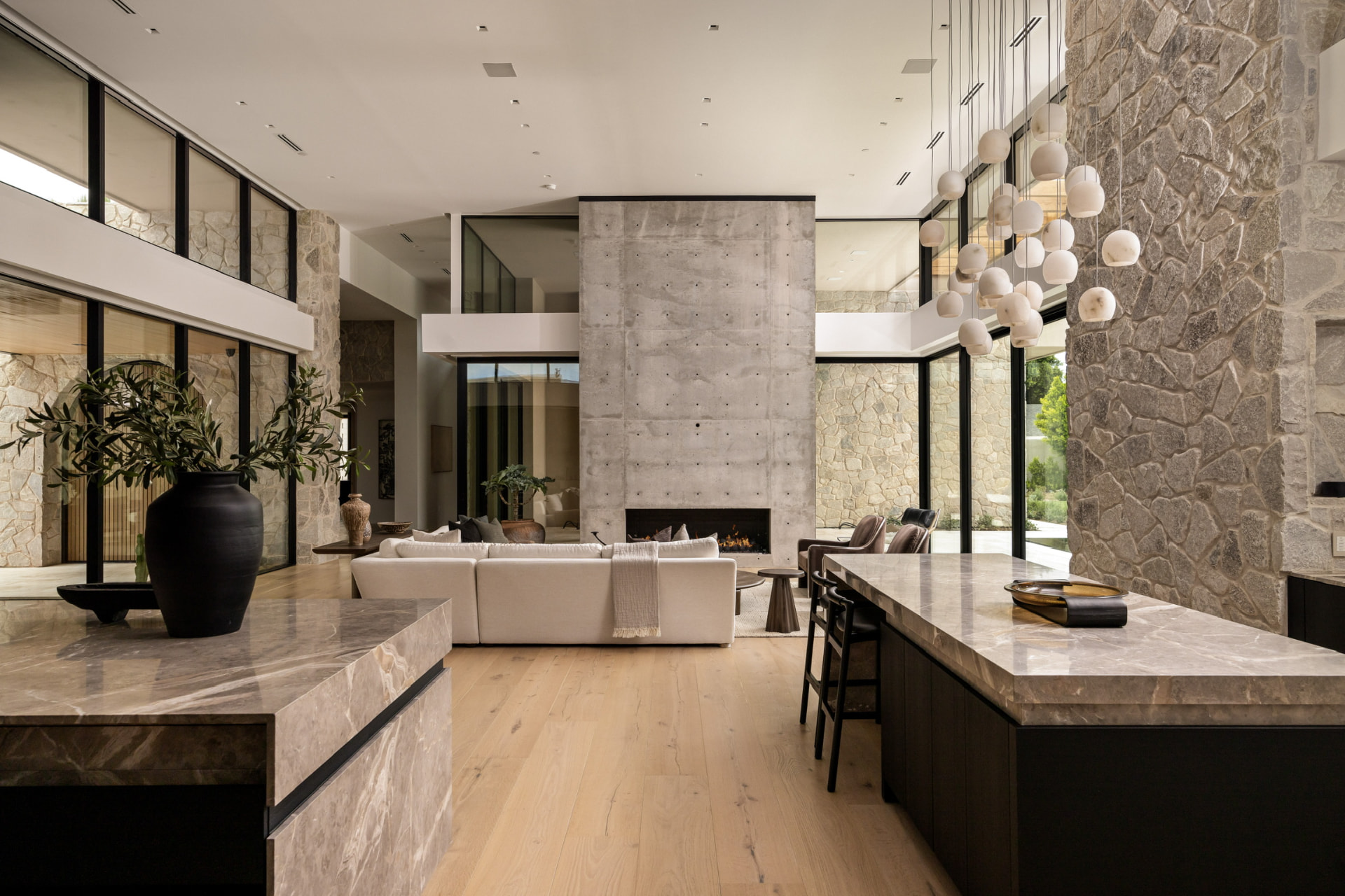 Living room with concrete fireplace and globe chandelier